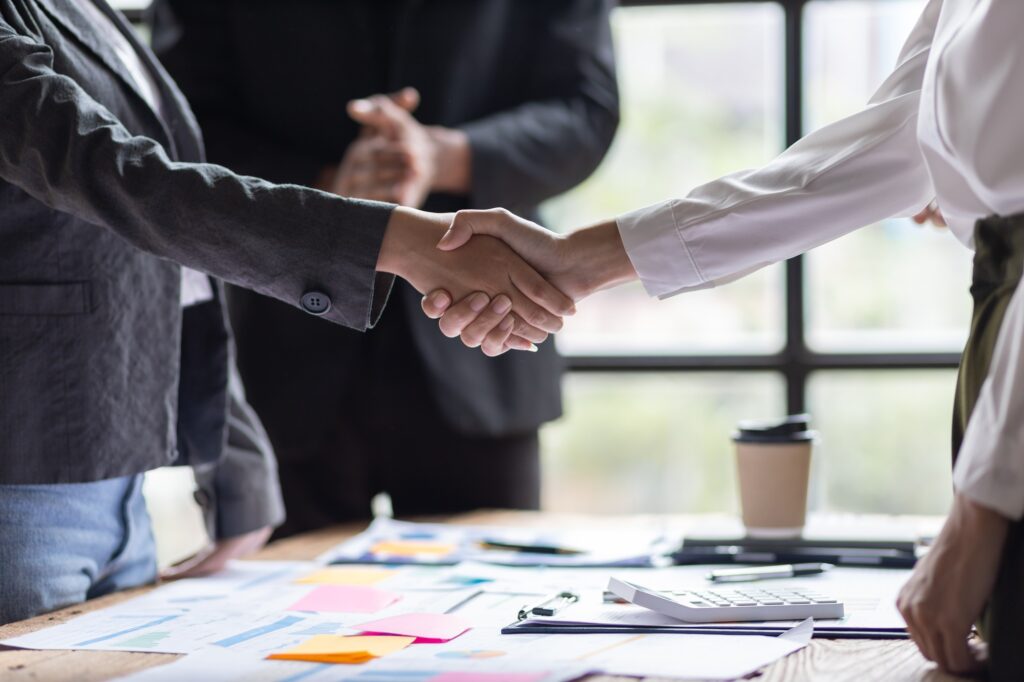 Business people shaking hands in business partnership meeting.